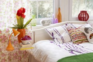 cozy stylish vintage corner of the natural wood bedroom with flower pattern curtain