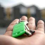 A man holding the keys to his first apartment