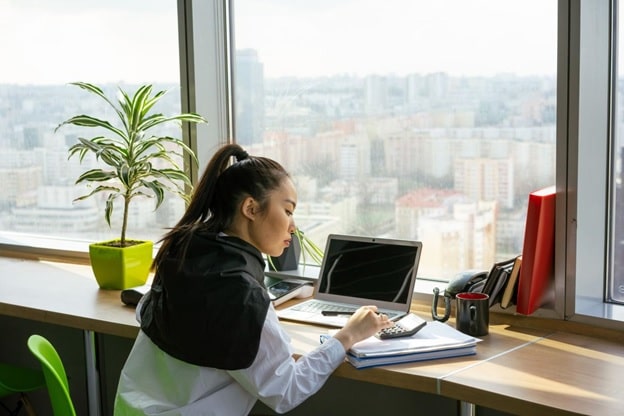 a woman working on her cover letter and résumé