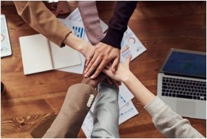 business owner shaking hands with the employees