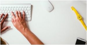 a person typing on a keyboard